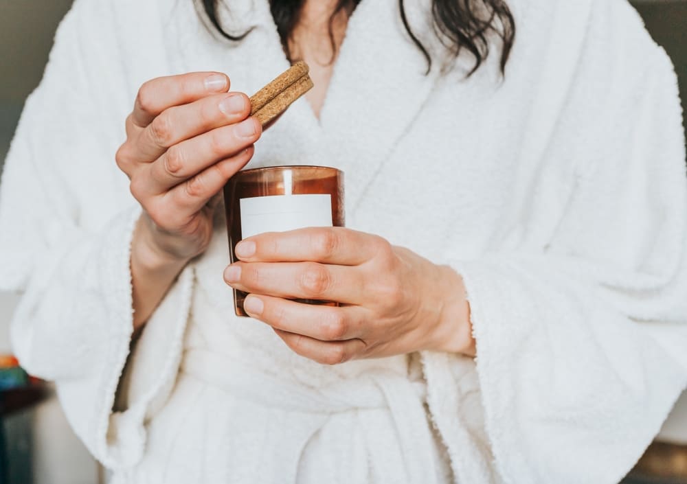 Woman opening candle jar